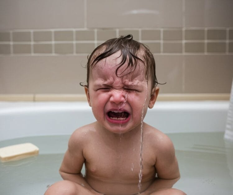 an image of a kid crying in a bath tub with no bubbles and bland soap